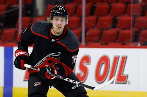 RALEIGH, NORTH CAROLINA – JANUARY 28: Ryan Dzingel #18 of the Carolina Hurricanes looks on during the third period of their game against the Tampa Bay Lightning at PNC Arena on January 28, 2021, in Raleigh, North Carolina. (Photo by Jared C. Tilton/Getty Images)