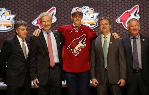 Jun 27, 2014; Philadelphia, PA, USA; Brendan Perlini poses for a photo with team officials after being selected as the number twelve overall pick to the Arizona Coyotes in the first round of the 2014 NHL Draft at Wells Fargo Center. Mandatory Credit: Bill Streicher-USA TODAY Sports