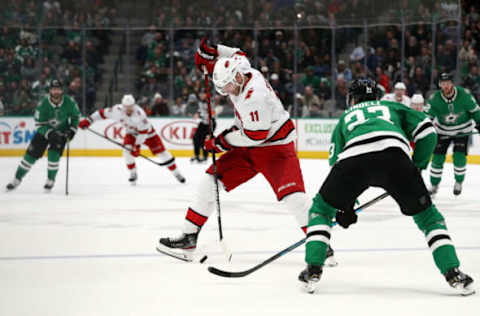 DALLAS, TEXAS – FEBRUARY 11: Jordan Staal #11 of the Carolina Hurricanes skates the puck against Esa Lindell #23 of the Dallas Stars in the second period at American Airlines Center on February 11, 2020 in Dallas, Texas. (Photo by Ronald Martinez/Getty Images)