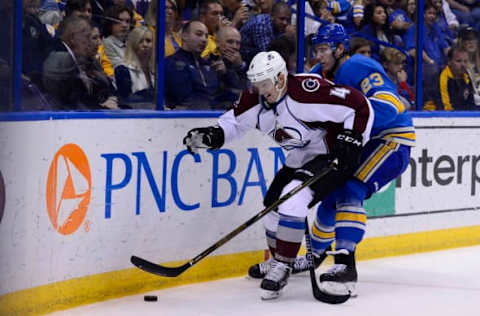 Apr 9, 2017; St. Louis, MO, USA; Colorado Avalanche defenseman Tyson Barrie (4) and St. Louis Blues right wing Dmitrij Jaskin (23) battle for the puck during the third period at Scottrade Center. The Blues won 3-2. Mandatory Credit: Jeff Curry-USA TODAY Sports