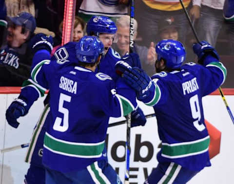 Oct 10, 2015; Vancouver, British Columbia, CAN; Vancouver Canucks forward Brandon Prust (9) celebrates his goal with defenseman Luca Sbisa (5) and forward Brandon Prust (9) against Calgary Flames goaltender Jonas Hiller (1) (not pictured) during the second period at Rogers Arena. Mandatory Credit: Anne-Marie Sorvin-USA TODAY Sports