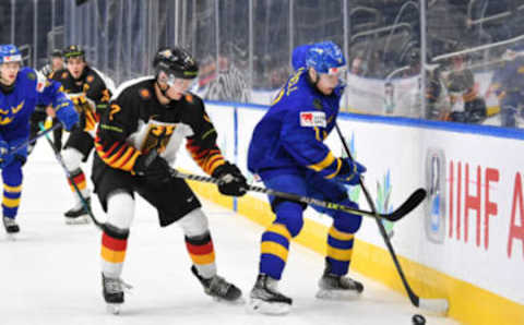 EDMONTON, AB – AUGUST 15: Fabian Lysell #11 of Sweden battles for the puck against Nikolaus Heigl #7 of Germany in the IIHF World Junior Championship on August 15, 2022, at Rogers Place in Edmonton, Alberta, Canada (Photo by Andy Devlin/ Getty Images)