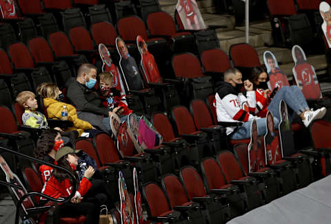 Fans sit among the cut outs. (Photo by Elsa/Getty Images)