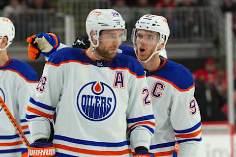 Nov 10, 2022; Raleigh, North Carolina, USA; Edmonton Oilers center Connor McDavid (97) talks to center Leon Draisaitl (29) against the Carolina Hurricanes during the second period at PNC Arena. Mandatory Credit: James Guillory-USA TODAY Sports