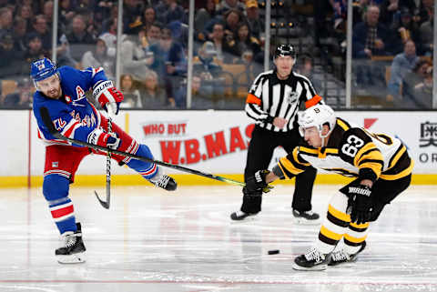 BOSTON, MA – MARCH 27: New York Rangers defenseman Kevin Shattenkirk (22) dumps the puck past Boston Bruins left wing Brad Marchand (63) during a game between the Boston Bruins and the New York Rangers on March 27, 2019, at TD Garden in Boston, Massachusetts. (Photo by Fred Kfoury III/Icon Sportswire via Getty Images)