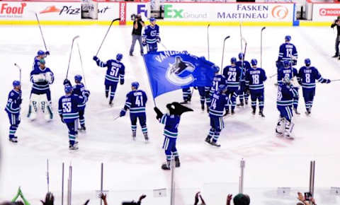 Apr 11, 2015; Vancouver, British Columbia, CAN; The Vancouver Canucks celebrate the win during overtime against the Edmonton Oilers at Rogers Arena. The Vancouver Canucks won 5-4 in overtime. Mandatory Credit: Anne-Marie Sorvin-USA TODAY Sports