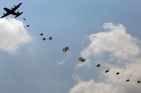 FORT BRAGG, NC – AUGUST 06: Paratroopers in the First Brigade of the US Army’s 82nd Airborne Division parachute from a C-130 plane during a training jump August 6, 2010 at Camp Mackall, North Carolina. The First Brigade, which just returned from a year-long tour in Iraq, were required to take the parachute jump as part the 82nd Airborne regulations in keeping all paratroopers’ jump training current. (Photo by Chris Hondros/Getty Images)