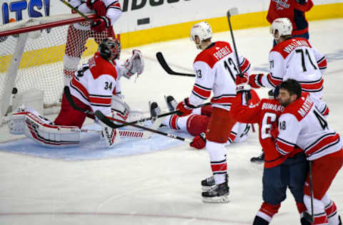 WASHINGTON, DC – APRIL 24: Washington Capitals left wing Andre Burakovsky (65) scores in the first period against Carolina Hurricanes goaltender Petr Mrazek (34) on April 24, 2019, at the Capital One Arena in Washington, D.C. in the first round of the Stanley Cup Playoffs. (Photo by Mark Goldman/Icon Sportswire via Getty Images)