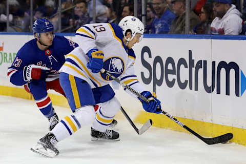 Apr 10, 2023; New York, New York, USA; Buffalo Sabres center Peyton Krebs (19) plays the puck against New York Rangers defenseman Adam Fox (23) during the first period at Madison Square Garden. Mandatory Credit: Brad Penner-USA TODAY Sports