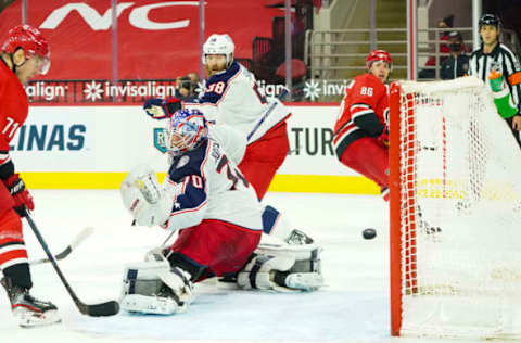 Feb 15, 2021; Raleigh, North Carolina, USA; Carolina Hurricanes left wing Teuvo Teravainen (86) scores a second period goal past Columbus Blue Jackets goaltender Joonas Korpisalo (70) at PNC Arena. Mandatory Credit: James Guillory-USA TODAY Sports