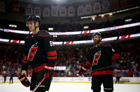 RALEIGH, NORTH CAROLINA – MAY 30: Martin Necas #88 and Jordan Martinook #48 of the Carolina Hurricanes exit the ice following their 6-2 defeat against the New York Rangers in Game Seven of the Second Round of the 2022 Stanley Cup Playoffs at PNC Arena on May 30, 2022, in Raleigh, North Carolina. (Photo by Jared C. Tilton/Getty Images)