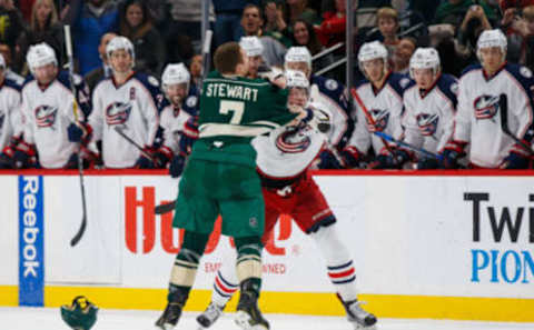 Dec 31, 2016; Saint Paul, MN, USA; Minnesota Wild forward Chris Stewart (7) and Columbus Blue Jackets forward Josh Anderson (34) fight in the second period at Xcel Energy Center. Mandatory Credit: Brad Rempel-USA TODAY Sports