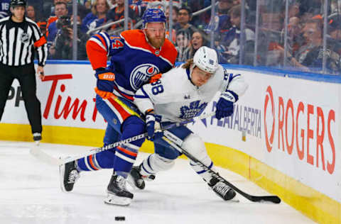 Mar 1, 2023; Edmonton, Alberta, CAN; Toronto Maple Leafs forward William Nylander (88) and Edmonton Oilers defensemen Mattias Ekholm (14) battle along the boards for a loose puck during the second period at Rogers Place. Mandatory Credit: Perry Nelson-USA TODAY Sports