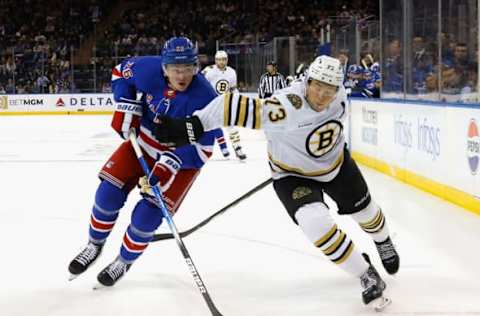 NEW YORK, NEW YORK – OCTOBER 05: Jimmy Vesey #26 of the New York Rangers skates against Charlie McAvoy #73 of the Boston Bruins at Madison Square Garden on October 05, 2023 in New York City. (Photo by Bruce Bennett/Getty Images)