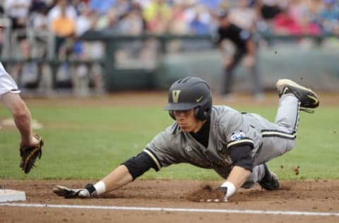 Jun 23, 2015; Omaha, NE, USA; Vanderbilt Commodores left fielder Jeren Kendall (3) dives back to first base but is tagged out during the second inning against the Virginia Cavaliers in game two of the College World Series Finals at TD Ameritrade Park. Mandatory Credit: Steven Branscombe-USA TODAY Sports. MLB.