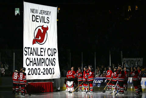 The New Jersey Devils watch the raising of the banner. (Photo by Chris Trotman/Getty Images)