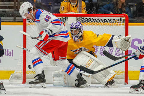 NASHVILLE, TENNESSEE – NOVEMBER 02: Brendan Lemieux #48 of the New York Rangers tries to corral a puck in front of goalie Juuse Saros #74 of the Nashville Predators during the third period at Bridgestone Arena on November 02, 2019 in Nashville, Tennessee. (Photo by Frederick Breedon/Getty Images)