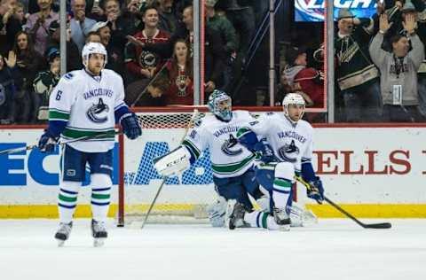 Feb 9, 2015; Saint Paul, MN, USA; Vancouver Canucks goalie Ryan Miller (30), defenseman Ryan Stanton (18) and defenseman Yannick Weber (6) look on after allowing a goal to Minnesota Wild forward Nino Niederreiter (not pictured) during the first period at Xcel Energy Center. Mandatory Credit: Brace Hemmelgarn-USA TODAY Sports