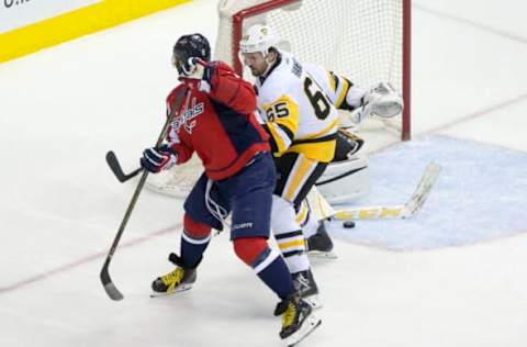 WASHINGTON, DC – MAY 10: Washington Capitals left wing Alex Ovechkin (8) flicks the puck past Pittsburgh Penguins defenseman Ron Hainsey (65) during game 7 of the Stanley Cup Eastern Conference semifinal between the Washington Capitals and the Pittsburgh Penguins on May 10, 2017, at the Verizon Center in Washington DC. Pittsburgh defeated the Washington Capitals 2-0.(Photo by Tony Quinn/Icon Sportswire via Getty Images)