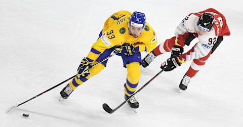 Sweden’s Mika Zibanejad (L) and Austria’s Clemens Unterweger vie for the puck during the group A match Sweden vs Austria of the 2018 IIHF Ice Hockey World Championship in Copenhagen, Denmark, on May 9, 2018. (Photo by HELMUT FOHRINGER / APA / AFP) / Austria OUT (Photo credit should read HELMUT FOHRINGER/AFP/Getty Images)