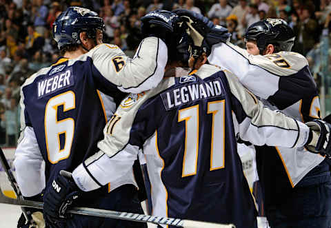 NASHVILLE, TN – MARCH 22: Shea Weber #6 and Ryan Suter #20 of the Nashville Predators congratulate teammate David Legwand Nashville, Tennessee. (Photo by Frederick Breedon/Getty Images)