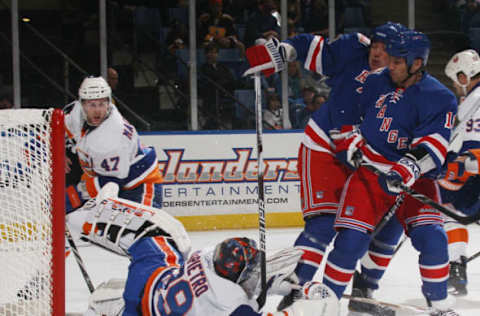 Rick DiPietro #39 of the New York Islanders makes the save on Sean Avery #16 of the New York Rangers on October 11, 2010 . (Photo by Bruce Bennett/Getty Images)