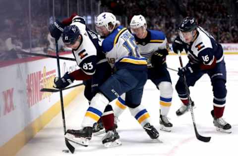 DENVER, COLORADO – JANUARY 02: Matt Nieto #83 and nikita Zadorov #16 of the Colorado Avalanche fight for the puck against Robert Thomas #18 and Tyler Bozak #21 of the St Louis Blues in the first period at the Pepsi Center on January 02, 2020 in Denver, Colorado. (Photo by Matthew Stockman/Getty Images)