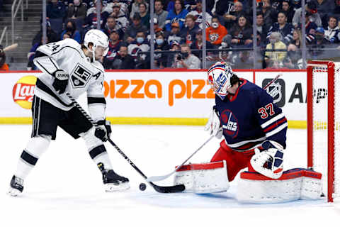 Apr. 2, 2022; Winnipeg, Manitoba, CAN; Winnipeg Jets goaltender Connor Hellebuyck (37) blocks a shot by Los Angeles Kings center Phillip Danault (24) in the first period at Canada Life Centre. Mandatory Credit: James Carey Lauder-USA TODAY Sports