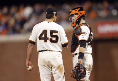 Oct 11, 2016; San Francisco, CA, USA; San Francisco Giants starting pitcher Matt Moore (45) and catcher Buster Posey (28) talk on the mound during game four of the 2016 NLDS playoff baseball game against the Chicago Cubs at AT&T Park. Mandatory Credit: John Hefti-USA TODAY Sports