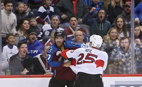 Nov 25, 2015; Denver, CO, USA; Colorado Avalanche center Andreas Martinsen (27) and Ottawa Senators right wing Chris Neil (25) fight during the third period at Pepsi Center. The Senators won 5-3. Mandatory Credit: Chris Humphreys-USA TODAY Sports