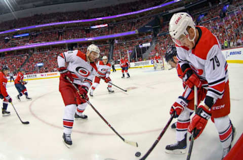 WASHINGTON, DC – APRIL 13: Carolina Hurricanes left wing Micheal Ferland (79) works the puck along the boards against Washington Capitals center Evgeny Kuznetsov (92) on April 13, 2019, at the Capital One Arena in Washington, D.C. in the first round of the Stanley Cup Playoffs. (Photo by Mark Goldman/Icon Sportswire via Getty Images)