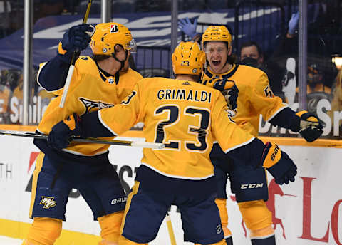 Nashville Predators center Nick Cousins (21) and Nashville Predators left wing Erik Haula (56) celebrate after a hat trick goal by Nashville Predators right wing Rocco Grimaldi (23) Mandatory Credit: Christopher Hanewinckel-USA TODAY Sports