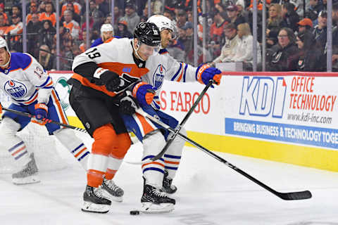 Oct 19, 2023; Philadelphia, Pennsylvania, USA; Philadelphia Flyers right wing Garnet Hathaway (19) checks Edmonton Oilers defenseman Evan Bouchard (2) during the first period at Wells Fargo Center. Mandatory Credit: Eric Hartline-USA TODAY Sports