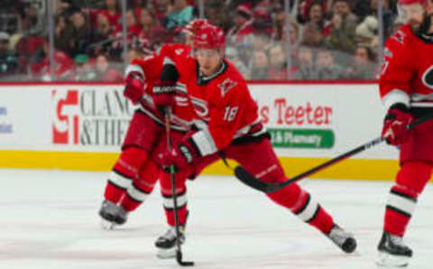 Dec 15, 2022; Raleigh, North Carolina, USA; Carolina Hurricanes center Jack Drury (18) skates with the puck against the Seattle Kraken during the first period at PNC Arena. Mandatory Credit: James Guillory-USA TODAY Sports