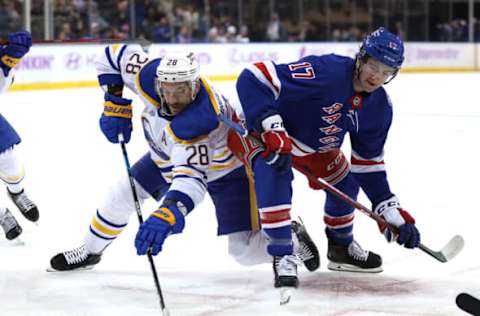 NEW YORK, NEW YORK – NOVEMBER 21: Zemgus Girgensons #28 of the Buffalo Sabres and Kevin Rooney #17 of the New York Rangers fight for the puck after a face-off at Madison Square Garden on November 21, 2021, in New York City. (Photo by Elsa/Getty Images)