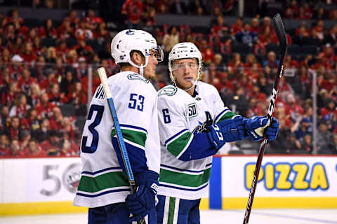 CALGARY, AB – OCTOBER 05: Vancouver Canucks Center Bo Horvat (53) and Right Wing Brock Boeser (6) talk between whistles during the third period of an NHL game where the Calgary Flames hosted the Vancouver Canucks on October 5, 2019, at the Scotiabank Saddledome in Calgary, AB. (Photo by Brett Holmes/Icon Sportswire via Getty Images)