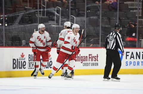 Mar 14, 2021; Detroit, Michigan, USA; Carolina Hurricanes defenseman Dougie Hamilton (19) celebrates his goal with teammates during the second period against the Detroit Red Wings at Little Caesars Arena. Mandatory Credit: Tim Fuller-USA TODAY Sports