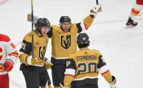 LAS VEGAS, NEVADA – DECEMBER 12: William Karlsson #71, Jonathan Marchessault #81, and Chandler Stephenson #20 of the Vegas Golden Knights celebrate Karlsson’s third-period goal against the Calgary Flames at T-Mobile Arena on December 12, 2023 in Las Vegas, Nevada. The Knights defeated the Flames 5-4 in overtime. (Photo by Candice Ward/Getty Images)