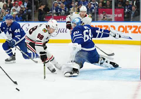 Oct 16, 2023; Toronto, Ontario, CAN; Chicago Blackhawks center Connor Bedard (98) battles for the puck in front of Toronto Maple Leafs goaltender Joseph Woll (60)  Credit: Nick Turchiaro-USA TODAY Sports