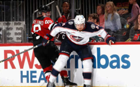 NEWARK, NEW JERSEY – OCTOBER 30: Vladislav Gavrikov #4 of the Columbus Blue Jackets backs into Fabian Zetterlund #49 of the New Jersey Devils during the second period at the Prudential Center on October 30, 2022 in Newark, New Jersey. (Photo by Bruce Bennett/Getty Images)