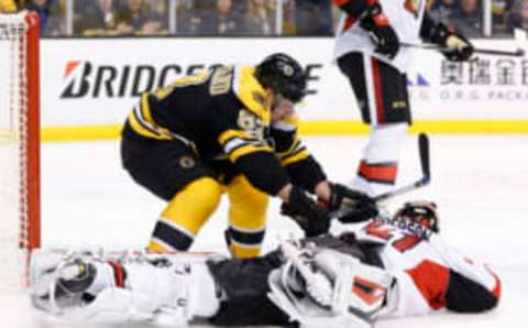 Boston Bruins left wing Brad Marchand (63) battles with Ottawa Senators goalie Craig Anderson (41) (Greg M. Cooper-USA TODAY Sports)