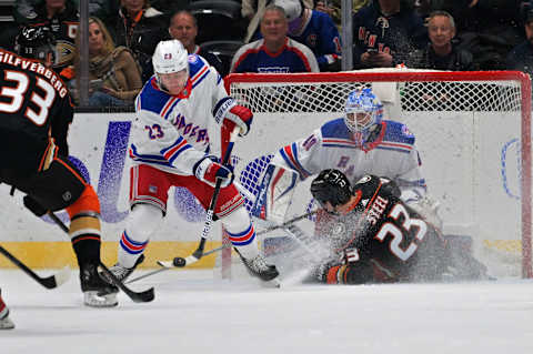 Jan 8, 2022; Anaheim, California, USA; New York Rangers defenseman Adam Fox (23) blocks a shot by Anaheim Ducks right wing Jakob Silfverberg (33) as Anaheim center Sam Steel (23) slides into New York goaltender Alexandar Georgiev (40) in the second period at Honda Center. Mandatory Credit: Jayne Kamin-Oncea-USA TODAY Sports