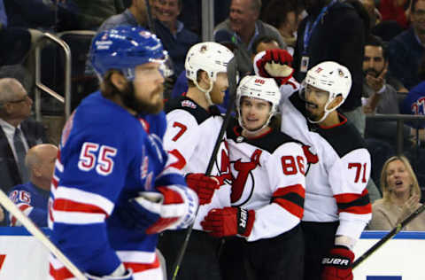 NEW YORK, NEW YORK – APRIL 24: Jack Hughes #86 of the New Jersey Devils (C) celebrates his goal against Igor Shesterkin #31 of the New York Rangers at 2:50 of the first period and is joined by Dougie Hamilton #7 (L) and Jonas Siegenthaler #71 (R) in Game Four of the First Round of the 2023 Stanley Cup Playoffs at Madison Square Garden on April 24, 2023 in New York, New York. (Photo by Bruce Bennett/Getty Images)