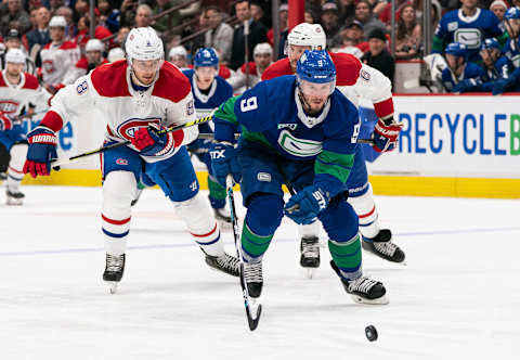 VANCOUVER, BC – DECEMBER 17: J.T. Miller #9 of the Vancouver Canucks chases down a loose puck after breaking free from Ben Chiarot #8 and Shea Weber #6 of the Montreal Canadiens during NHL action at Rogers Arena on December 17, 2019 in Vancouver, Canada. (Photo by Rich Lam/Getty Images)