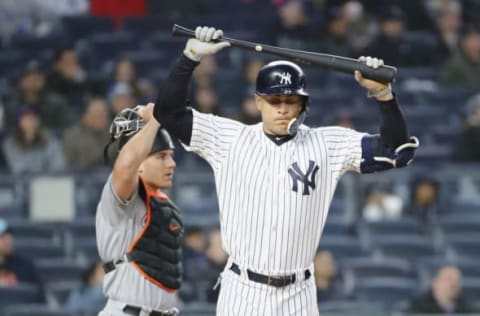 NEW YORK, NY – APRIL 17: Giancarlo Stanton #27 of the New York Yankees reacts after he hit a pop fly in the third inning as J.T. Realmuto #11 of the Miami Marlins defends at Yankee Stadium on April 17, 2018 in the Bronx borough of New York City. (Photo by Elsa/Getty Images)