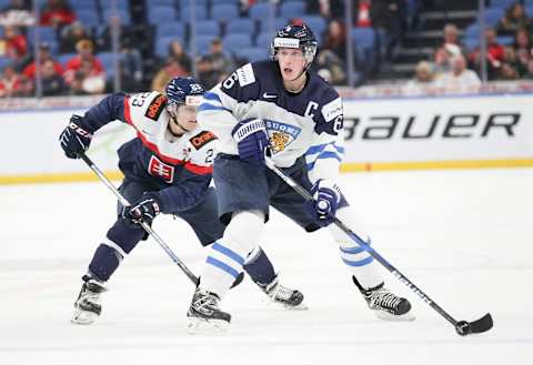 BUFFALO, NY – DECEMBER 30: Juuso Välimäki #6 of Finland skates the puck up ice with Samuel Solenský #23 of Slovakia applying pressure during the second period of play in the IIHF World Junior Championships at the KeyBank Center on December 30, 2017 in Buffalo, New York. (Photo by Nicholas T. LoVerde/Getty Images) *** Samuel Solenský; Juuso Välimäki