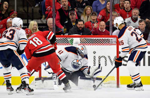 RALEIGH, NORTH CAROLINA – FEBRUARY 16: Mike Smith #41 of the Edmonton Oilers makes a save against the Carolina Hurricanes during the third period of their game at PNC Arena on February 16, 2020, in Raleigh, North Carolina. The Oilers won 4-3 in overtime. (Photo by Grant Halverson/Getty Images)