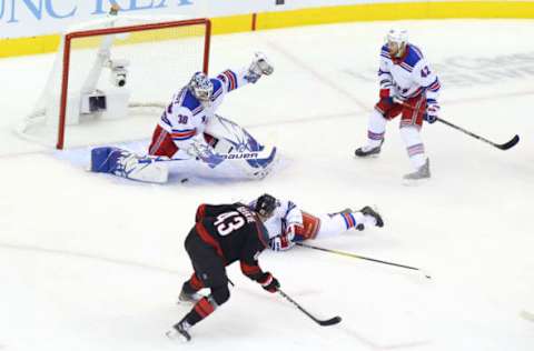 Henrik Lundqvist #30 of the New York Rangers saves a shot on goal from Morgan Geekie #43 of the Carolina Hurricanes (Photo by Andre Ringuette/Freestyle Photo/Getty Images)