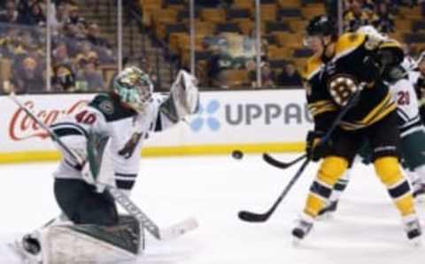 Oct 25, 2016; Boston, MA, USA; Minnesota Wild goalie Devan Dubnyk (40) makes a save as Boston Bruins right wing David Pastrnak (88) looks for the rebound during the third period of the Minnesota Wild