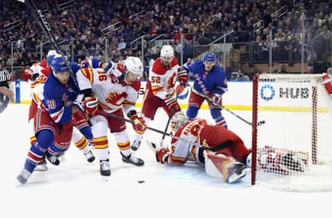 NEW YORK, NEW YORK – FEBRUARY 06: Will Cuylle #50 of the New York Rangers attempts to get past Nikita Zadorov #16 of the Calgary Flames at Madison Square Garden on February 06, 2023, in New York City. (Photo by Bruce Bennett/Getty Images)